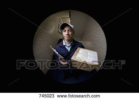 A delivery man with a package View Large Photo Image Stock Image - A delivery man with a package. Fotosearch