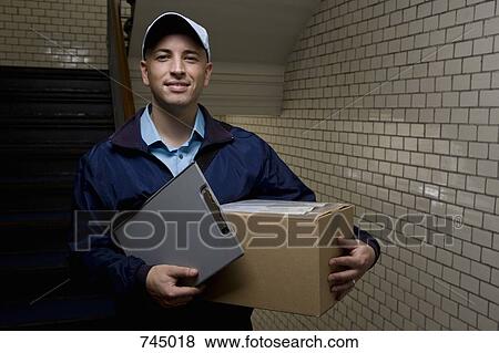 A delivery man with a package View Large Photo Image Stock Photo - A delivery man with a package. Fotosearch