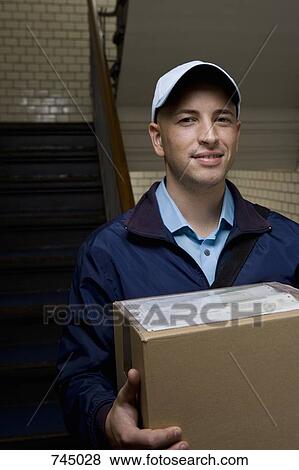 A delivery man with a package View Large Photo Image Stock Photo - A delivery man with a package. Fotosearch