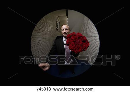 A man with a bouquet of roses pushing a doorbell, viewed through peephole View Large Photo Image Stock Image - A man with a bouquet of roses pushing a doorbell, viewed through peephole. Fotosearch