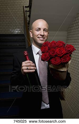 A man with roses and champagne View Large Photo Image Stock Photography - A man with roses and champagne. Fotosearch
