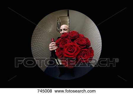 A man with roses and champagne viewed through a peephole View Large Photo Image Stock Photo - A man with roses and champagne viewed through a peephole. Fotosearch