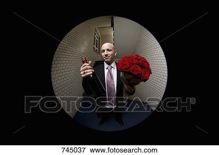 A man with roses and champagne viewed through a peephole View Large Photo Image Stock Photo - A man with roses and champagne viewed through a peephole. Fotosearch
