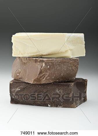Stock Image - Stack of dark, milk and white chocolate. Fotosearch