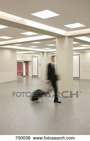 A man pulling a suitcase View Large Photo Image Stock Photo - A man pulling a suitcase. Fotosearch