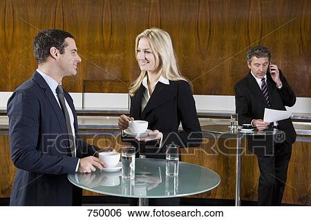 Stock Photograph - Business people in a cafe. Fotosearch