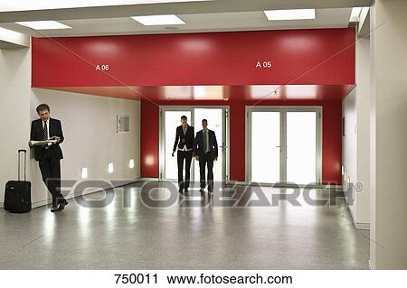 Business people in a lobby View Large Photo Image Stock Image - Business people in a lobby. Fotosearch