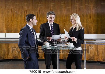 Business people meeting in a cafe View Large Photo Image Stock Photo - Business people meeting in a cafe. Fotosearch