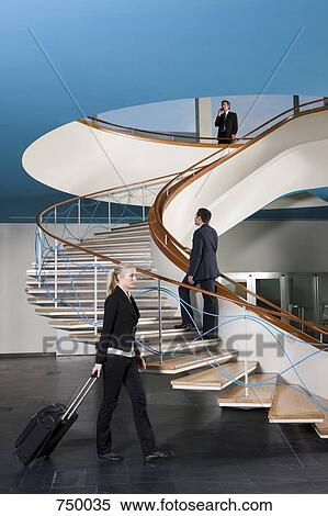 Stock Photography - Business people walking in the foyer of a building. Fotosearch