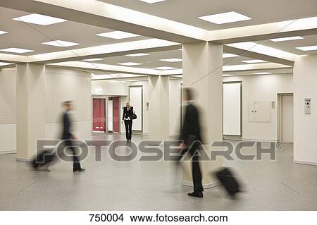 People pulling suitcases walking in different directions View Large Photo Image Picture - People pulling suitcases walking in different directions. Fotosearch