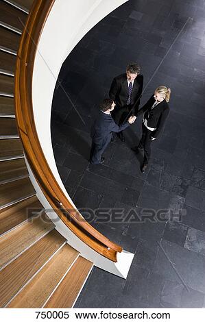 Three business people shaking hands View Large Photo Image Stock Photography - Three business people shaking hands. Fotosearch