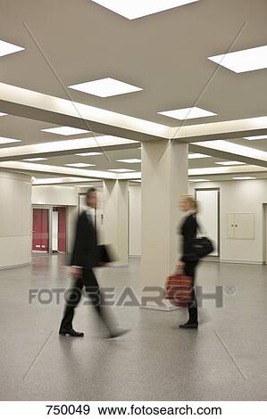 Two business people rushing past each other View Large Photo Image Stock Photo - Two business people rushing past each other. Fotosearch