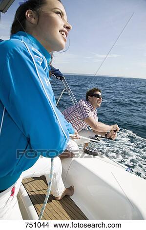 A couple adjusting the rigging on a yacht View Large Photo Image Picture - A couple adjusting the rigging on a yacht. Fotosearch