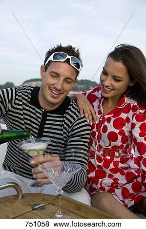 A couple enjoying champagne on a yacht View Large Photo Image Stock Photo - A couple enjoying champagne on a yacht. Fotosearch