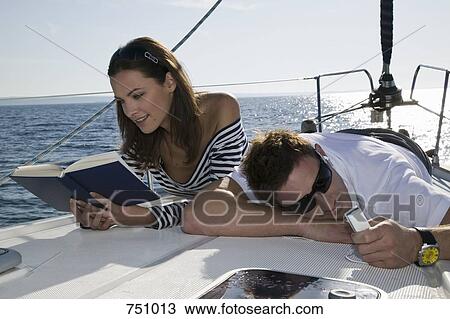 A couple relaxing on a yacht View Large Photo Image Stock Image - A couple relaxing on a yacht. Fotosearch