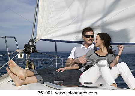 A couple relaxing on a yacht together View Large Photo Image Stock Image - A couple relaxing on a yacht together. Fotosearch
