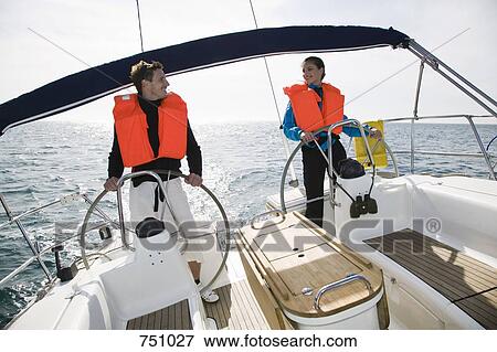 Stock Photo - A man and a woman sailing. Fotosearch