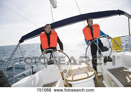 Stock Photo - A man and a woman sailing. Fotosearch