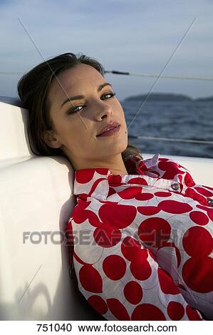 A woman relaxing on a yacht View Large Photo Image Stock Image - A woman relaxing on a yacht. Fotosearch