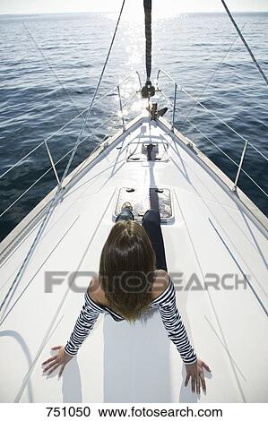 A woman sitting on the bow of a yacht View Large Photo Image Stock Image - A woman sitting on the bow of a yacht. Fotosearch