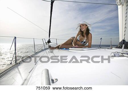 A woman sunbathing on a yacht View Large Photo Image Stock Photo - A woman sunbathing on a yacht. Fotosearch