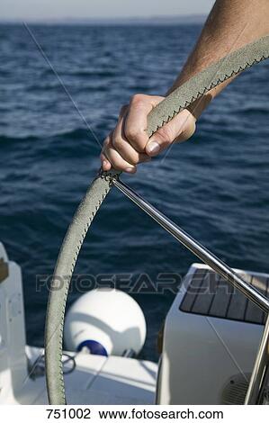 Detail of a man at the helm of a yacht View Large Photo Image Stock Image - Detail of a man at the helm of a yacht. Fotosearch