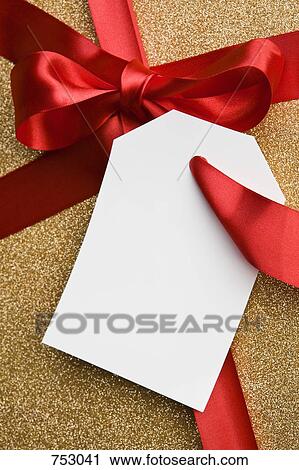 A gift tied with a red ribbon View Large Photo Image Stock Image - A gift tied with a red ribbon. Fotosearch