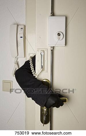 A gloved hand reaching inside a locked door View Large Photo Image Stock Photo - A gloved hand reaching inside a locked door. Fotosearch