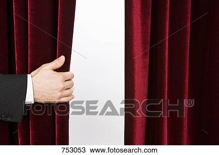 A hand opening a red velvet curtain View Large Photo Image Stock Image - A hand opening a red velvet curtain. Fotosearch