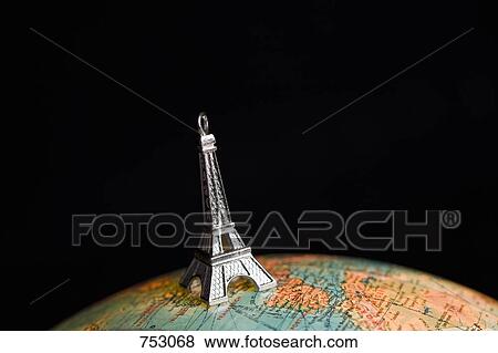 A statue of the Eiffel Tower on top of a globe View Large Photo Image Stock Photo - A statue of the Eiffel Tower on top of a globe. Fotosearch