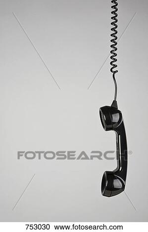 A telephone receiver hanging View Large Photo Image Stock Image - A telephone receiver hanging. Fotosearch