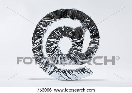 At sign wrapped in silver foil View Large Photo Image Stock Photograph - At sign wrapped in silver foil. Fotosearch