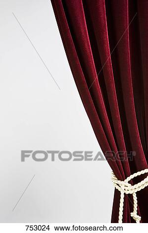 Picture - Red velvet curtain tied with a gold rope. Fotosearch