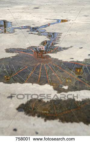 A ferris wheel reflected in a puddle View Large Photo Image Stock Image - A ferris wheel reflected in a puddle. Fotosearch