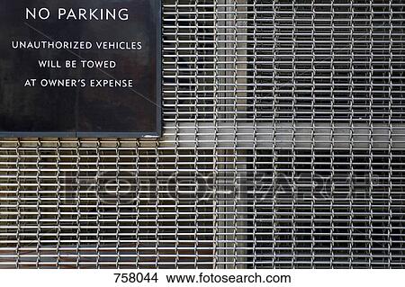 No Parking sign attached to a metal grid View Large Photo Image Picture - No Parking sign attached to a metal grid. Fotosearch