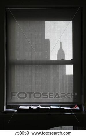 Silhouette of the Empire State Building through a window blind View Large Photo Image Stock Photo - Silhouette of the Empire State Building through a window blind. Fotosearch