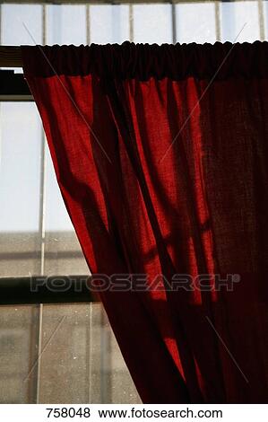 Sunlight shining through a window onto a red curtain View Large Photo Image Stock Photo - Sunlight shining through a window onto a red curtain. Fotosearch
