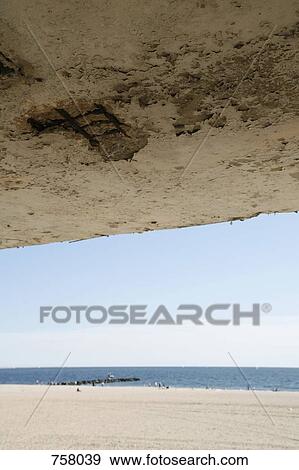 View of a beach from underneath a balcony View Large Photo Image Stock Photo - View of a beach from underneath a balcony. Fotosearch