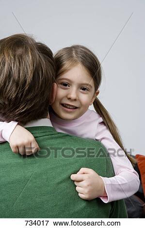 A daughter embracing her father View Large Photo Image Stock Photo - A daughter embracing her father. Fotosearch