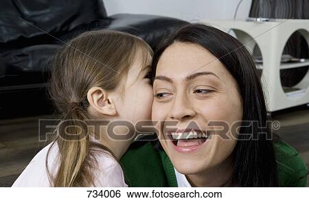A daughter whispering in her mother's ear View Large Photo Image Stock Photograph - A daughter whispering in her mother's ear. Fotosearch