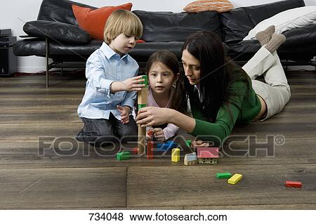 A mother and her children playing with building blocks View Large Photo Image Stock Photo - A mother and her children playing with building blocks. Fotosearch