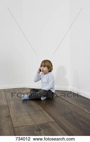 A young boy talking on a cell phone View Large Photo Image Stock Image - A young boy talking on a cell phone. Fotosearch