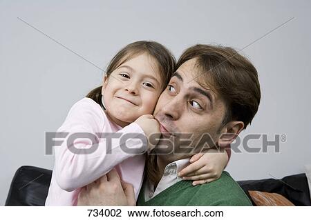 A young girl pretend punching her father in the mouth View Large Photo Image Stock Image - A young girl pretend punching her father in the mouth. Fotosearch