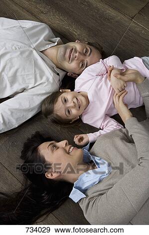 Stock Photo - Portrait of two parents and their child. Fotosearch