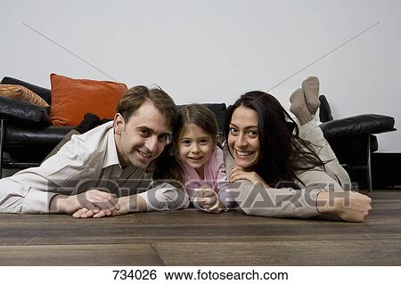 Stock Photograph - Portrait of two parents and their child. Fotosearch