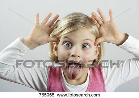 Stock Photography - A little girl making a funny face. Fotosearch