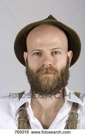 Stock Photo - A man wearing an alpine hat and lederhosen. Fotosearch