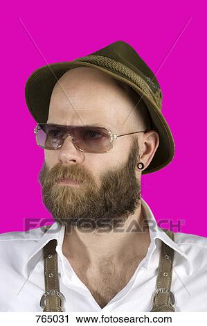 A man wearing an alpine hat, lederhosen and sunglasses View Large Photo Image Stock Image - A man wearing an alpine hat, lederhosen and sunglasses. Fotosearch