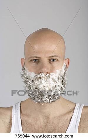 Picture - A man with shaving cream all over his beard. Fotosearch