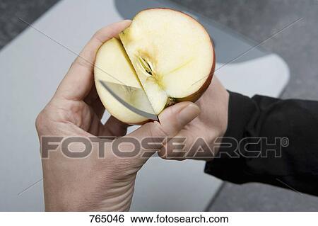 A person cutting through an apple and into their thumb View Large Photo Image Stock Photograph - A person cutting through an apple and into their thumb. Fotosearch